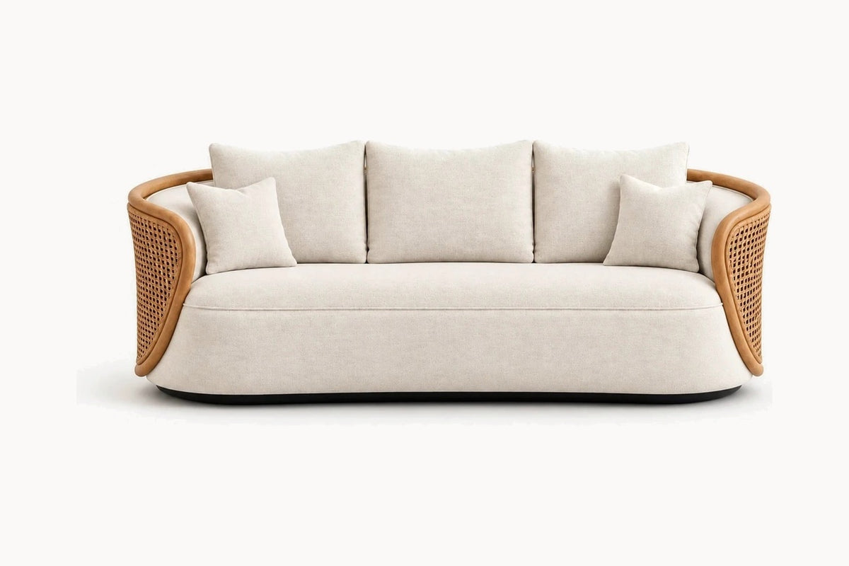 A modern curved three-seater sofa with light beige textured fabric upholstery and natural woven rattan armrests, shown against a plain white background.