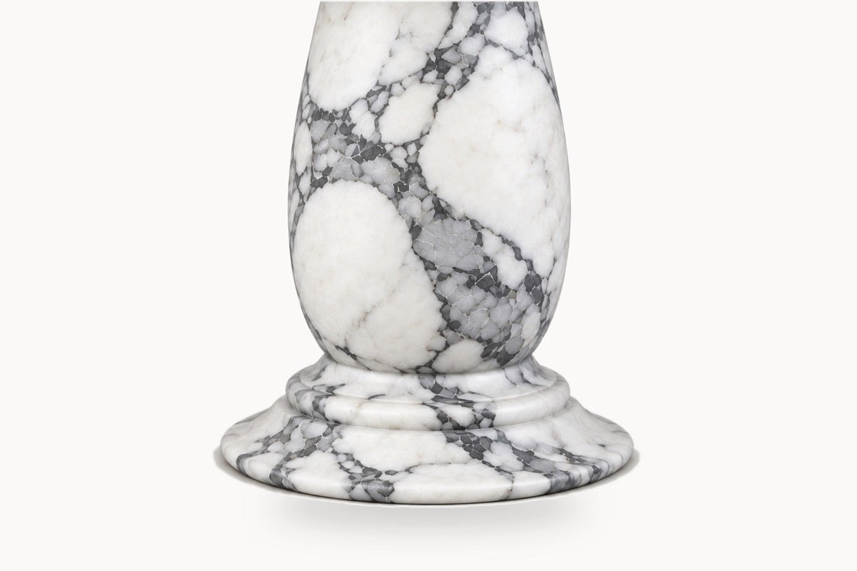A white marble candlestick base with dramatic gray and black veining, shown on a clean white background.